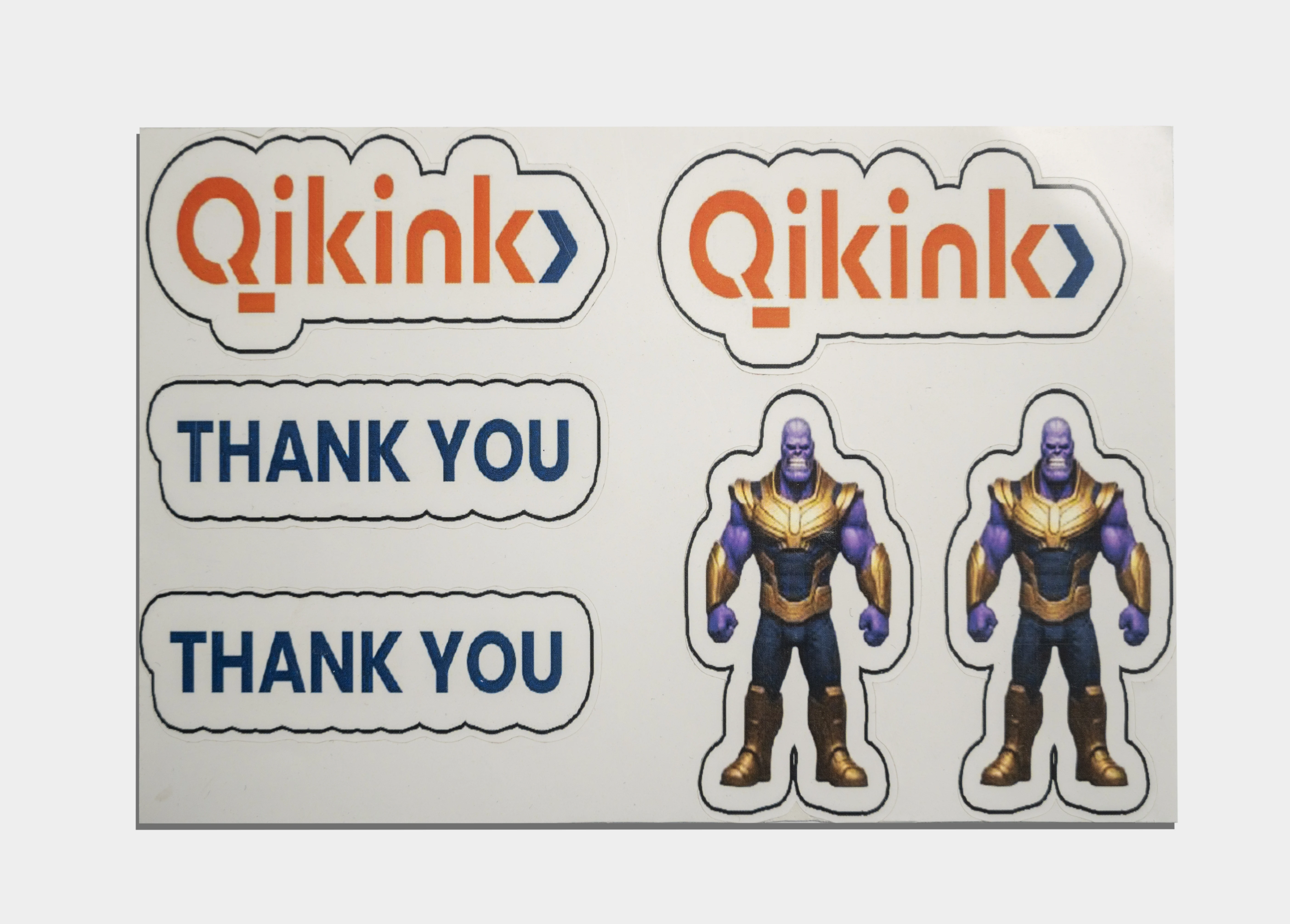 Printed thank you sticker card sheet showing Qikink logo stickers and thank you text stickers