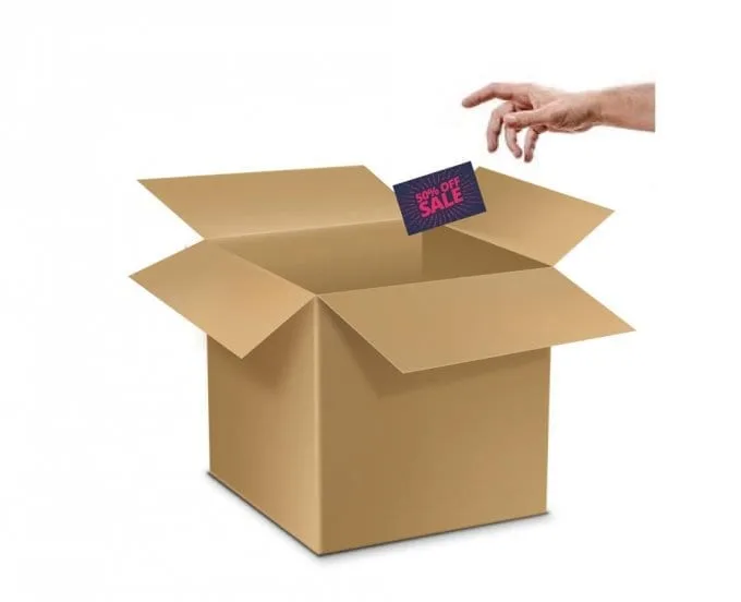 Hand placing a custom card into an open shipping box